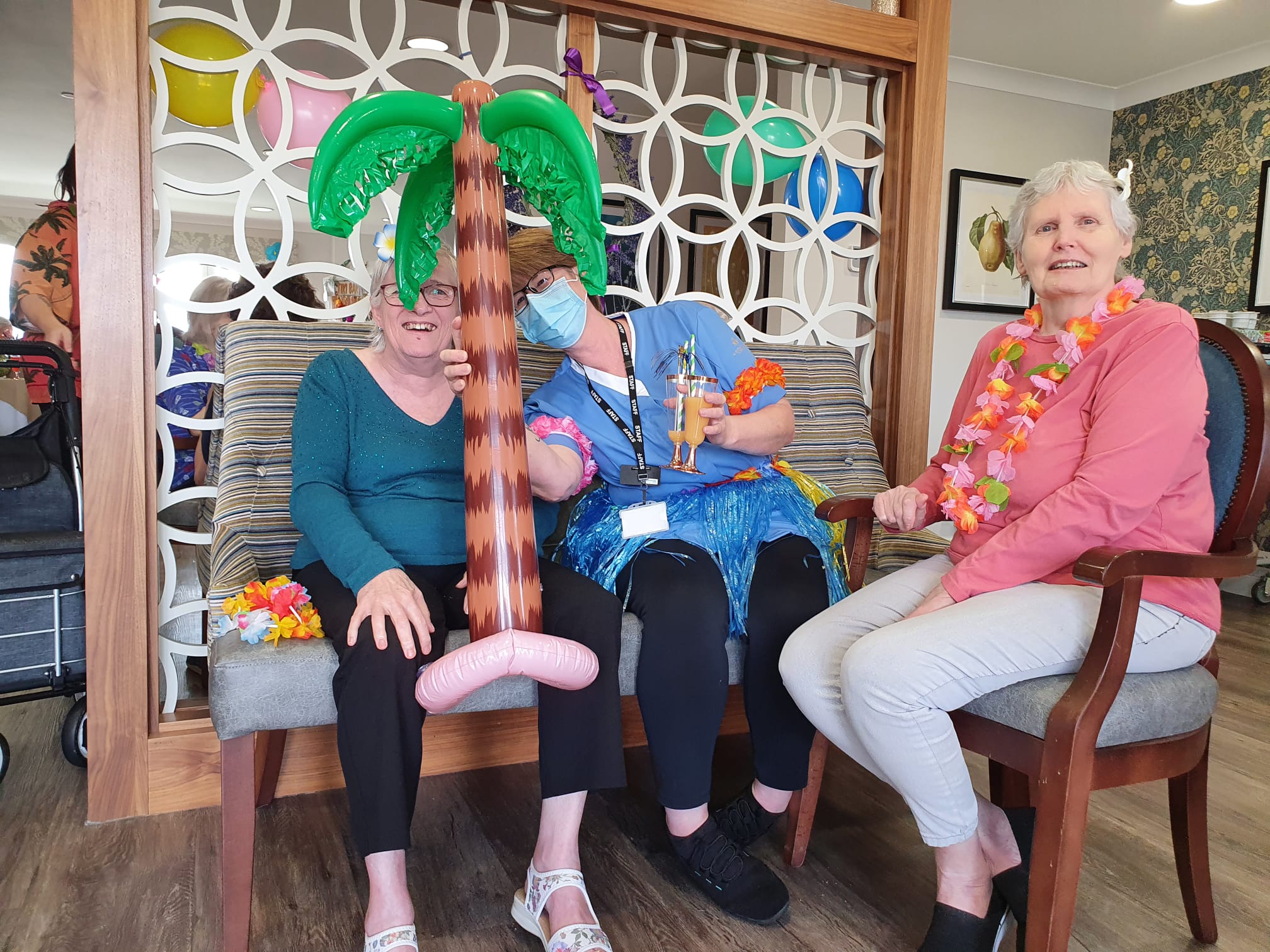 Residents and Staff Celebrating at Hawaiian Party