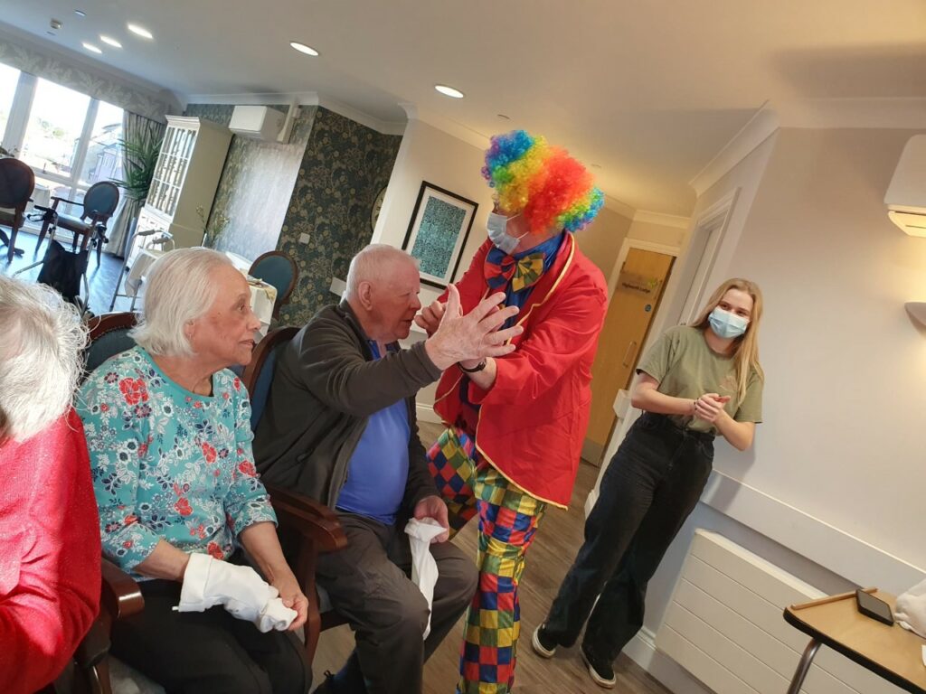 residents with entertainer dressed as a clown