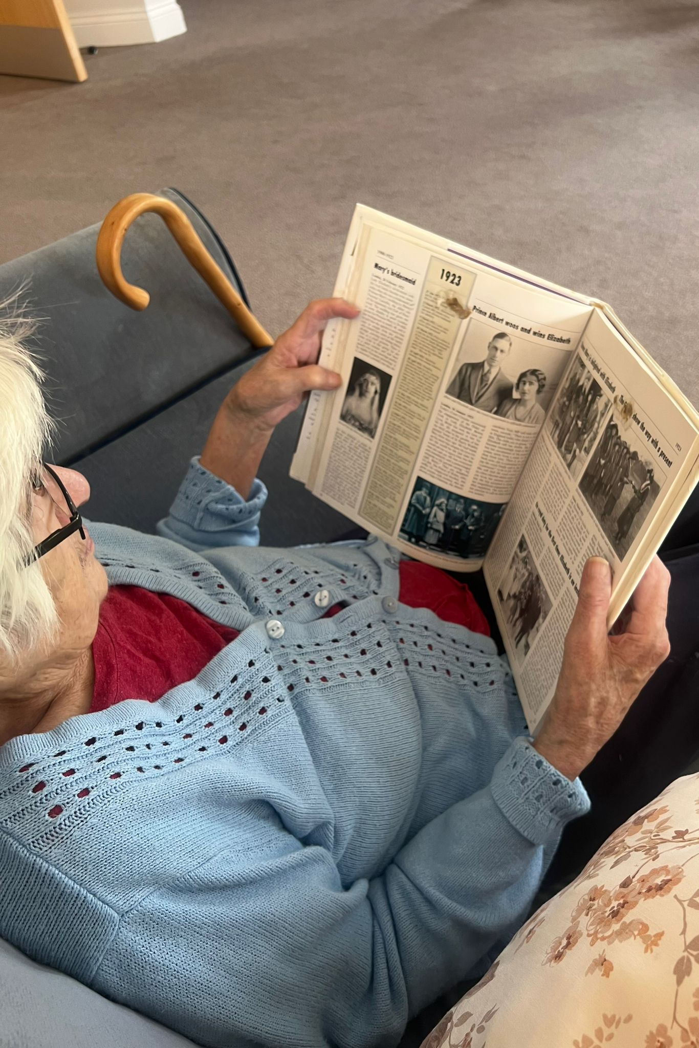 A resident reading about the King on Coronation Day at Ridgeway Rise Care Home