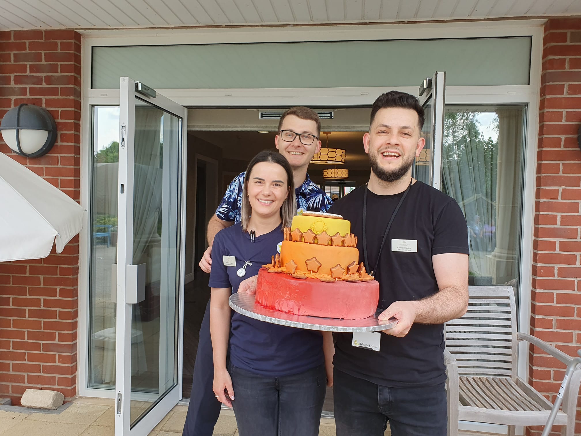 Our staff posing with a thank you cake on Glad to Care Week