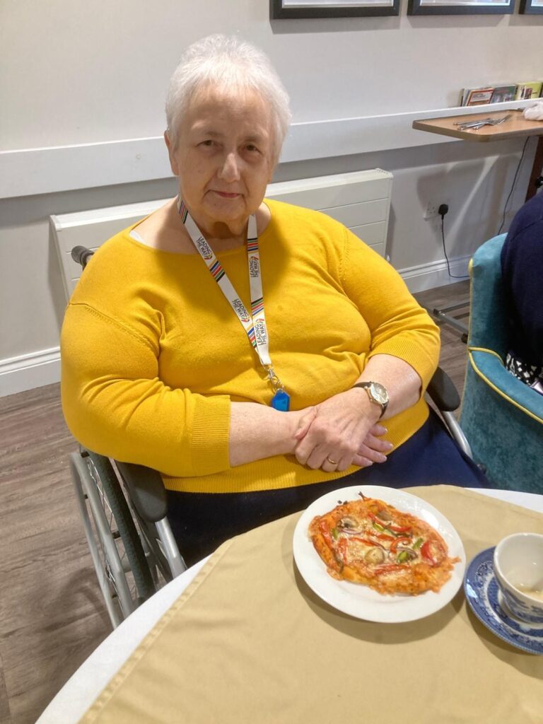 resident enjoying a pizza