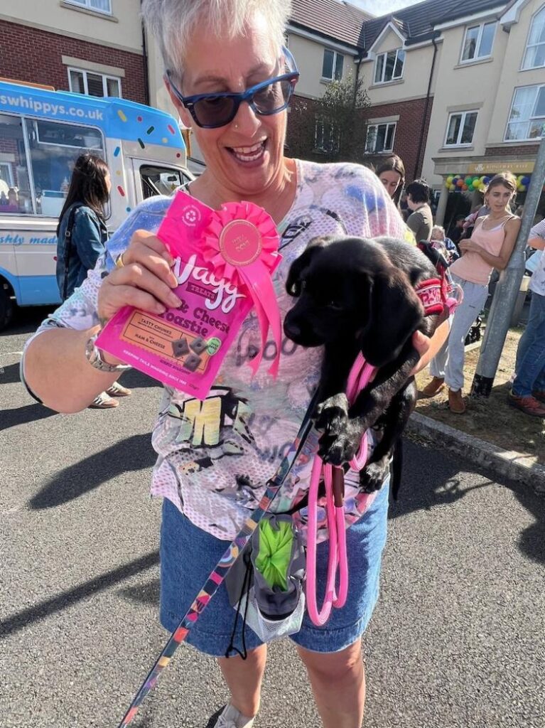 dog with a rosette and treats at the dog show