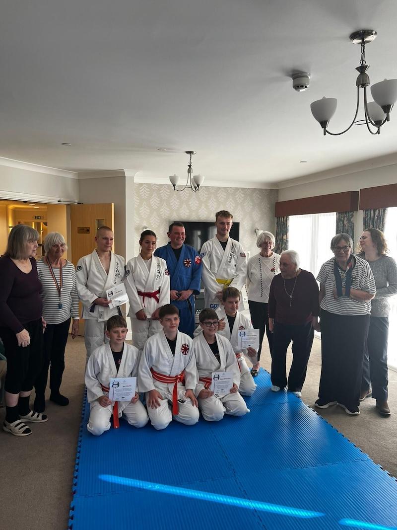 a group photo of the members of dracos dojo visiting our home