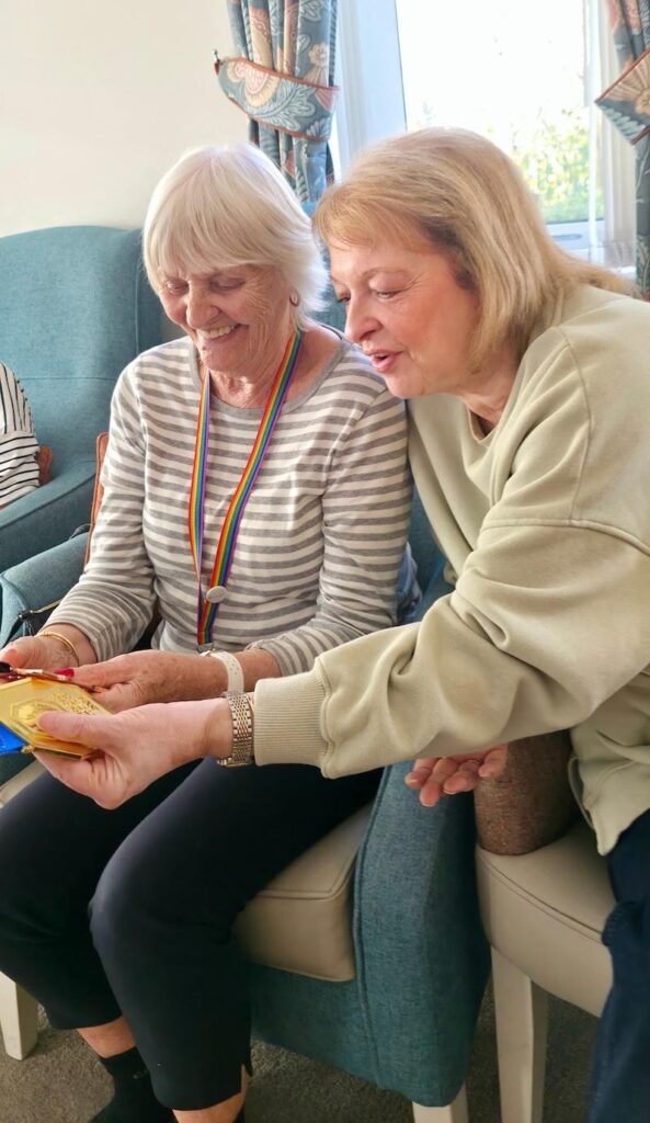 female resident holding a gold medal in her hand from a jiu jitzu championship