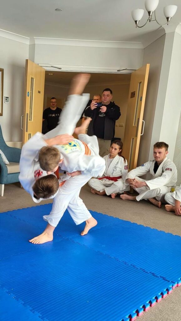 two of our visitors performing jiu jitzu on each other to show our residents
