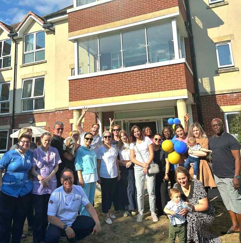 a group photo of our team, family members and the community
