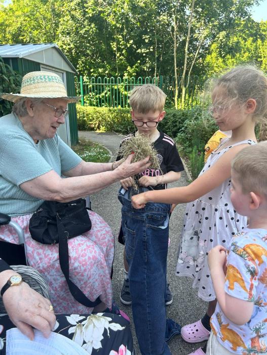 resident and children making scarecrow
