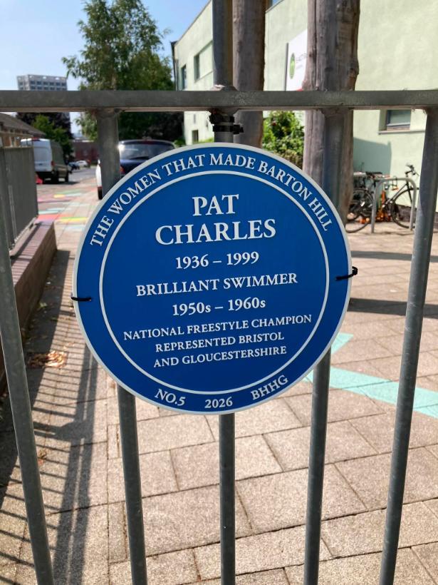 a blue plaque with the name pat charles