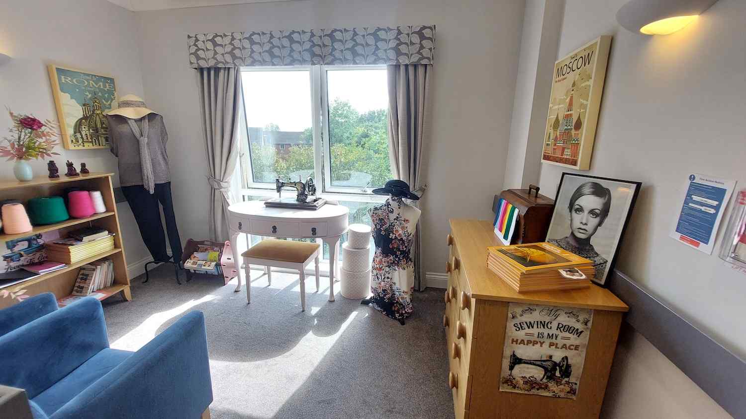 a seamstress destination point with a model, sewing machine and coloured string