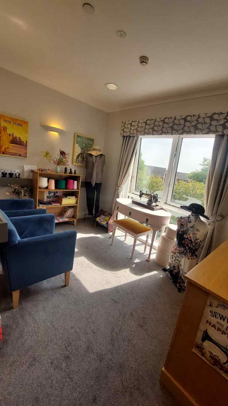 a seamstress destination point with a model, sewing machine and coloured string