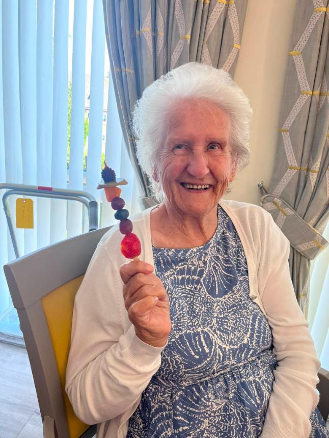 older lady with fruit