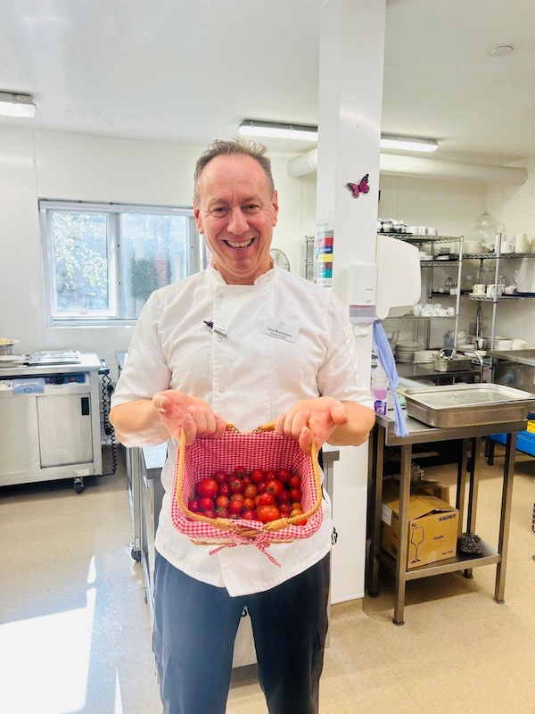 chef holding a box of tomatoes